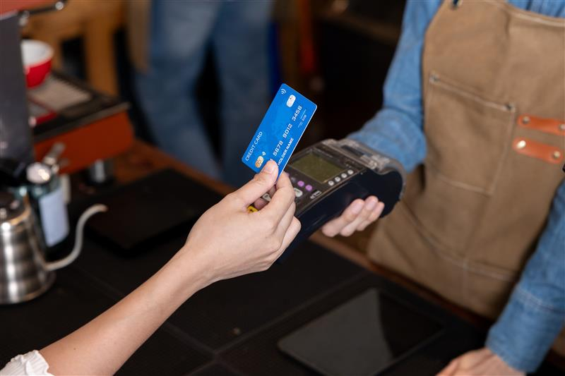 Someone tapping a credit card to card reader.